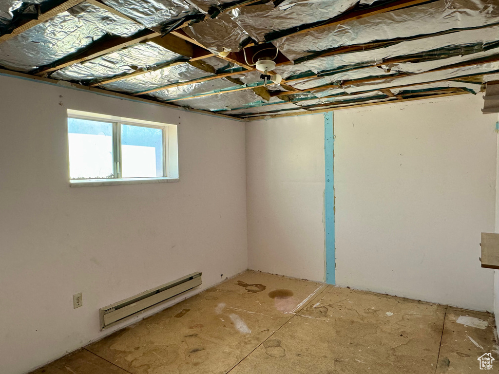 Basement with a baseboard heating unit