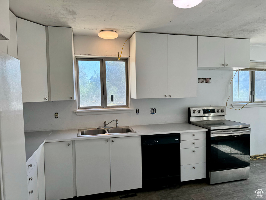 Kitchen featuring black dishwasher, dark wood-type flooring, electric range, and white cabinets