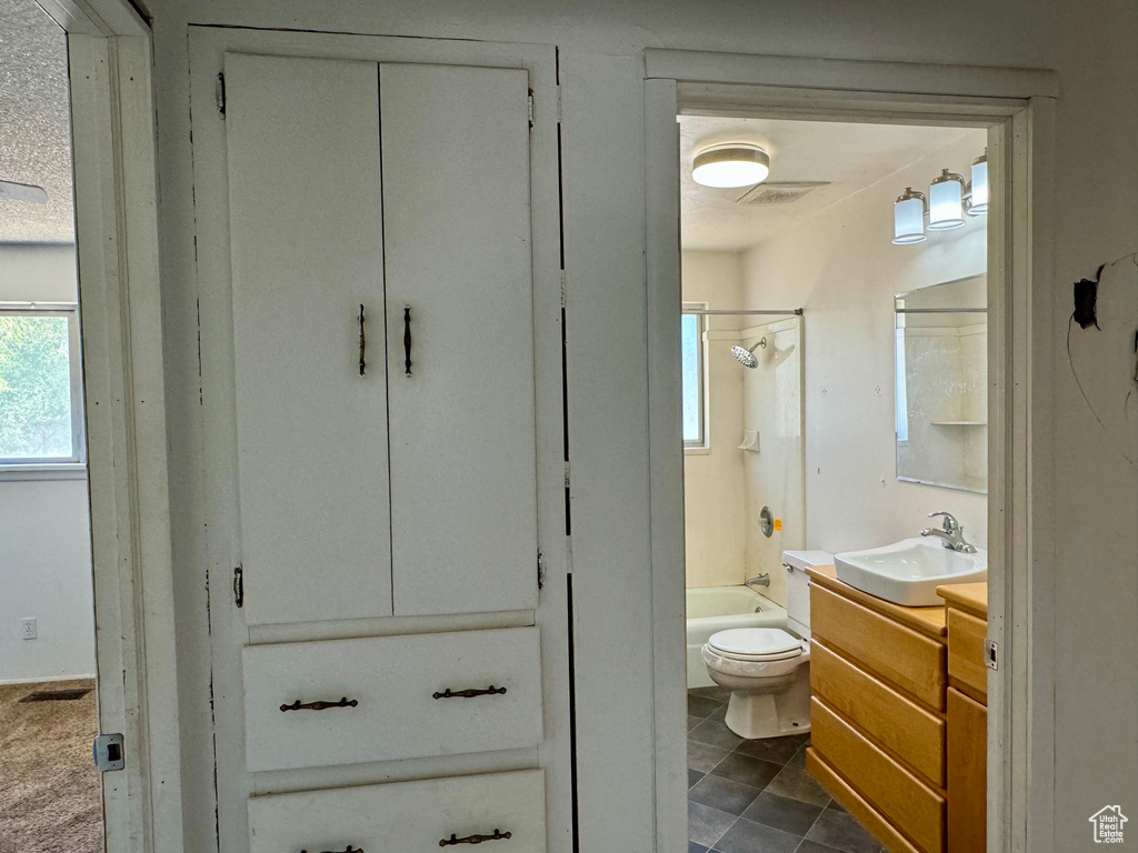 Full bathroom with a textured ceiling, vanity, toilet, and shower / bath combination