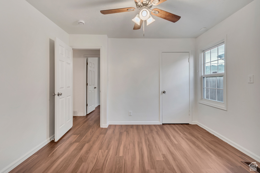 Unfurnished bedroom with hardwood / wood-style floors and ceiling fan