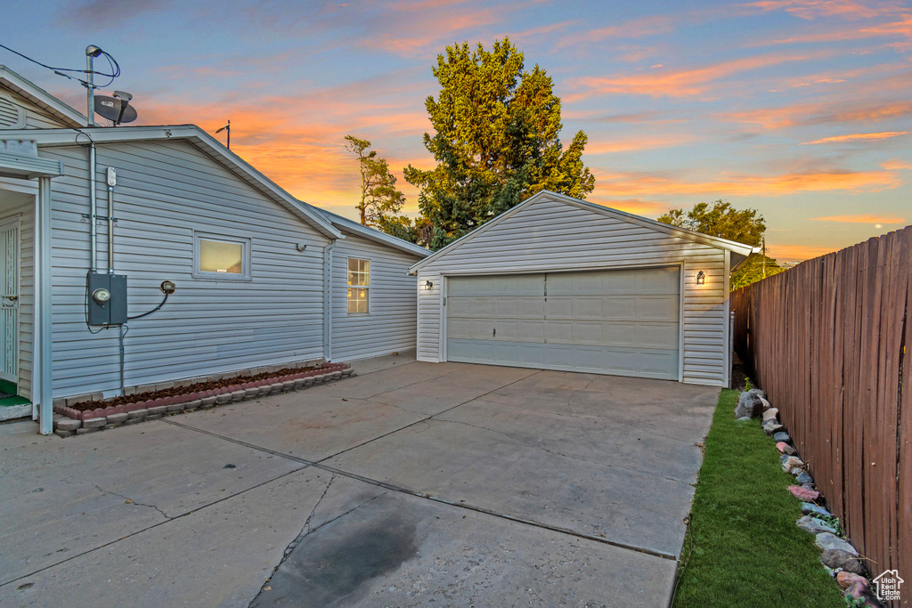 View of garage at dusk