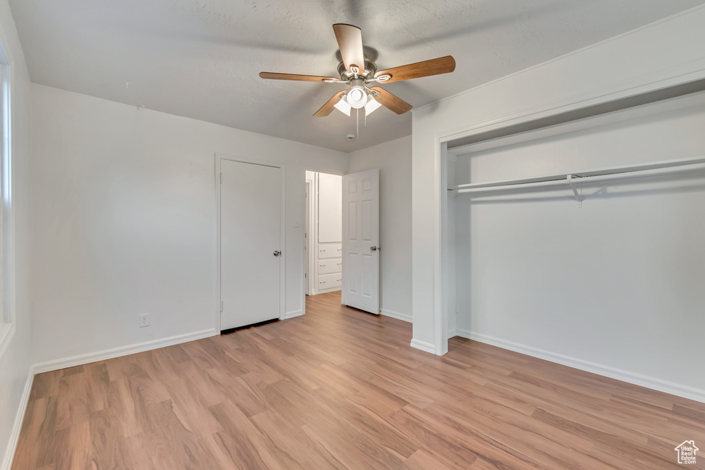 Unfurnished bedroom featuring light hardwood / wood-style flooring and ceiling fan