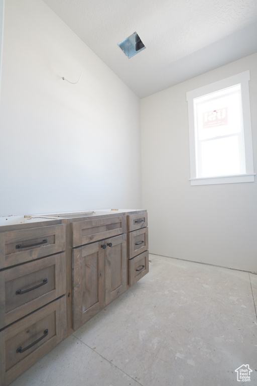 Bathroom with concrete flooring and a textured ceiling