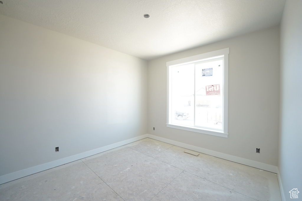 Spare room with a textured ceiling