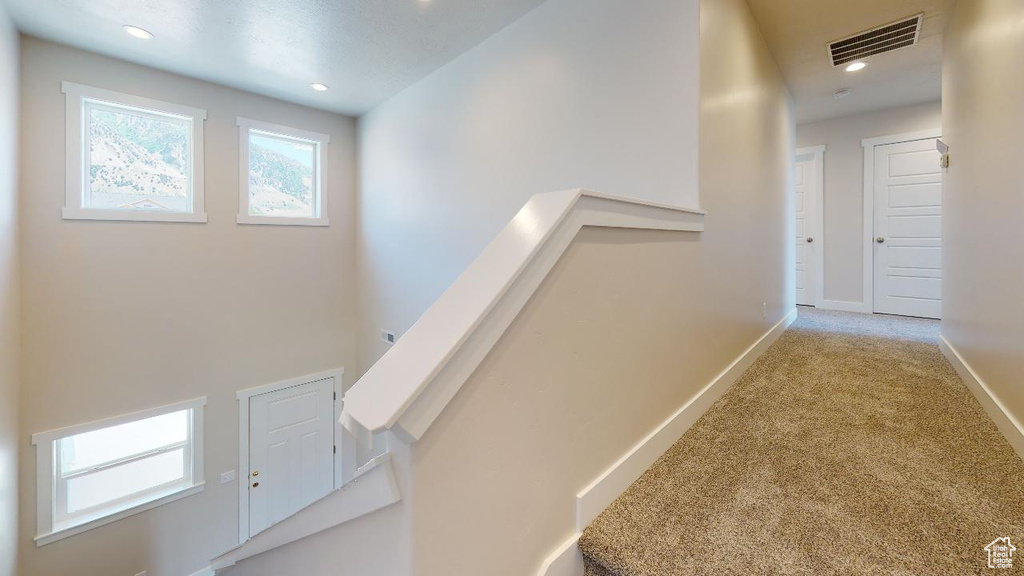 Hallway with light colored carpet