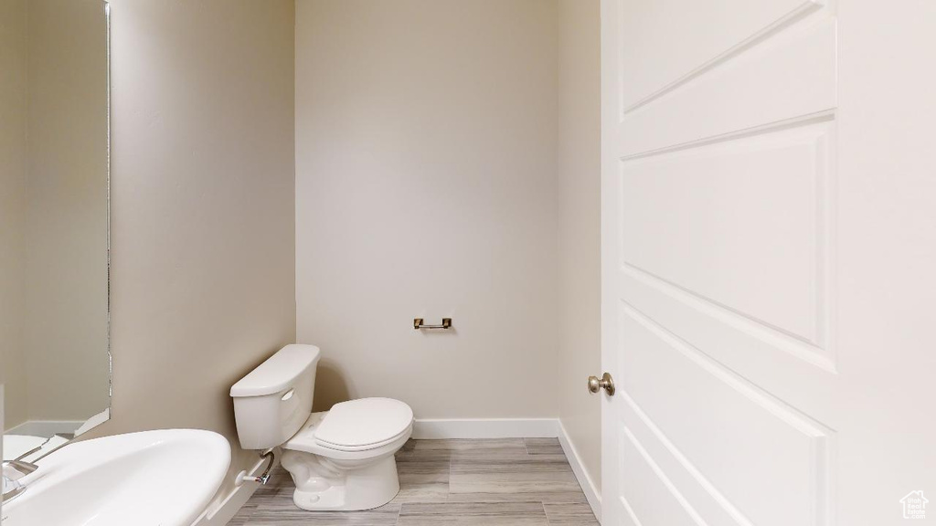 Bathroom featuring toilet and hardwood / wood-style flooring