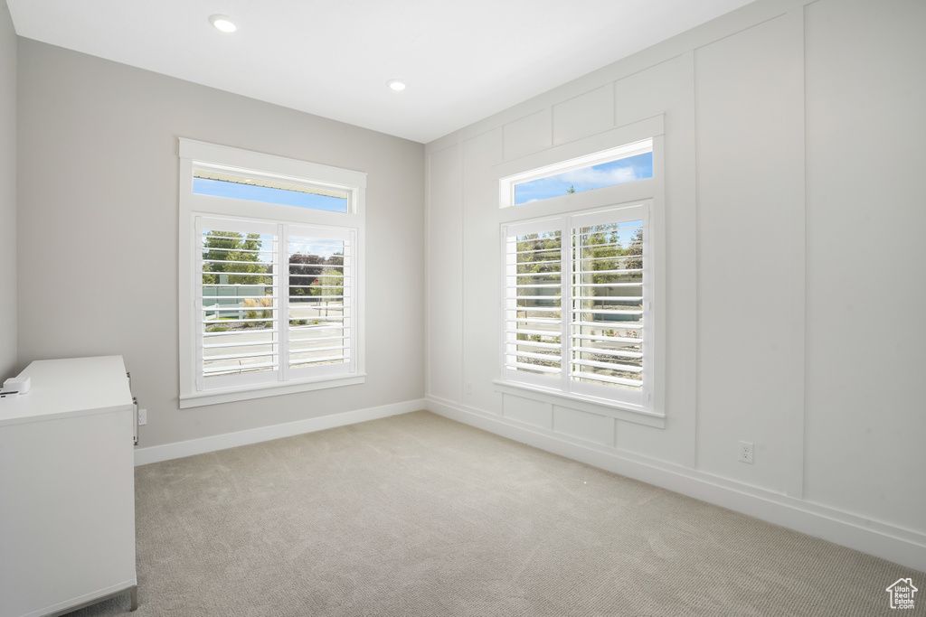 Carpeted spare room with plenty of natural light