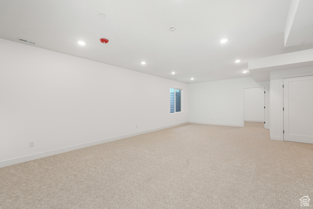 Empty room with light colored carpet