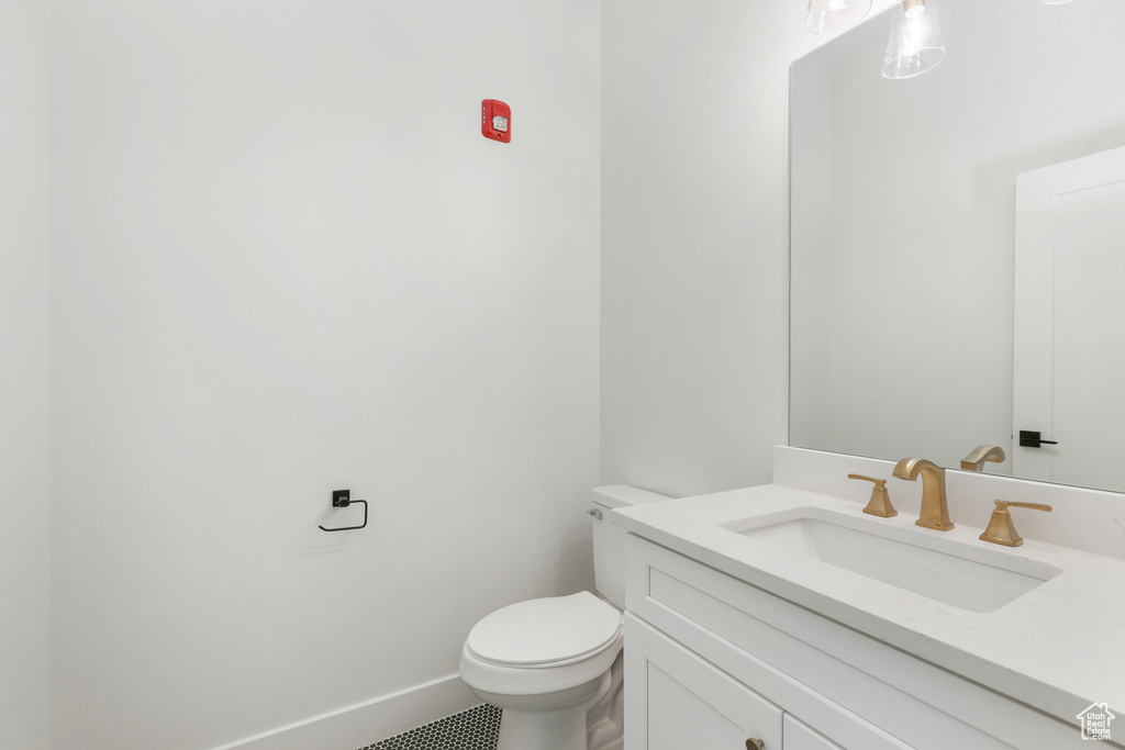 Bathroom featuring vanity, toilet, and tile patterned floors