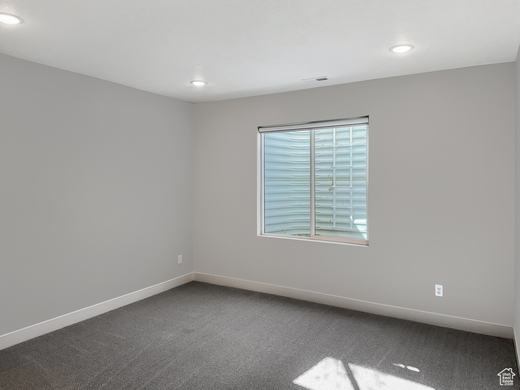 Spare room featuring carpet flooring