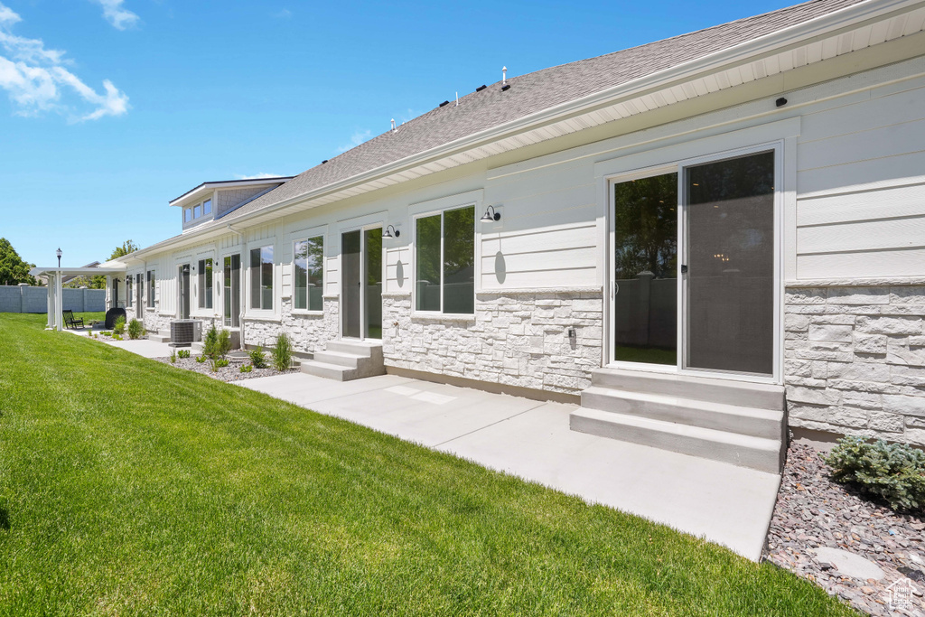 Exterior space with central AC and a yard