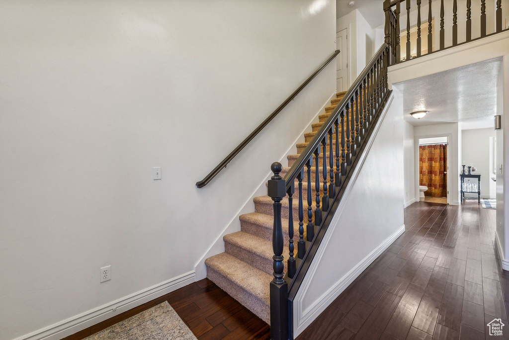 Staircase featuring wood-type flooring