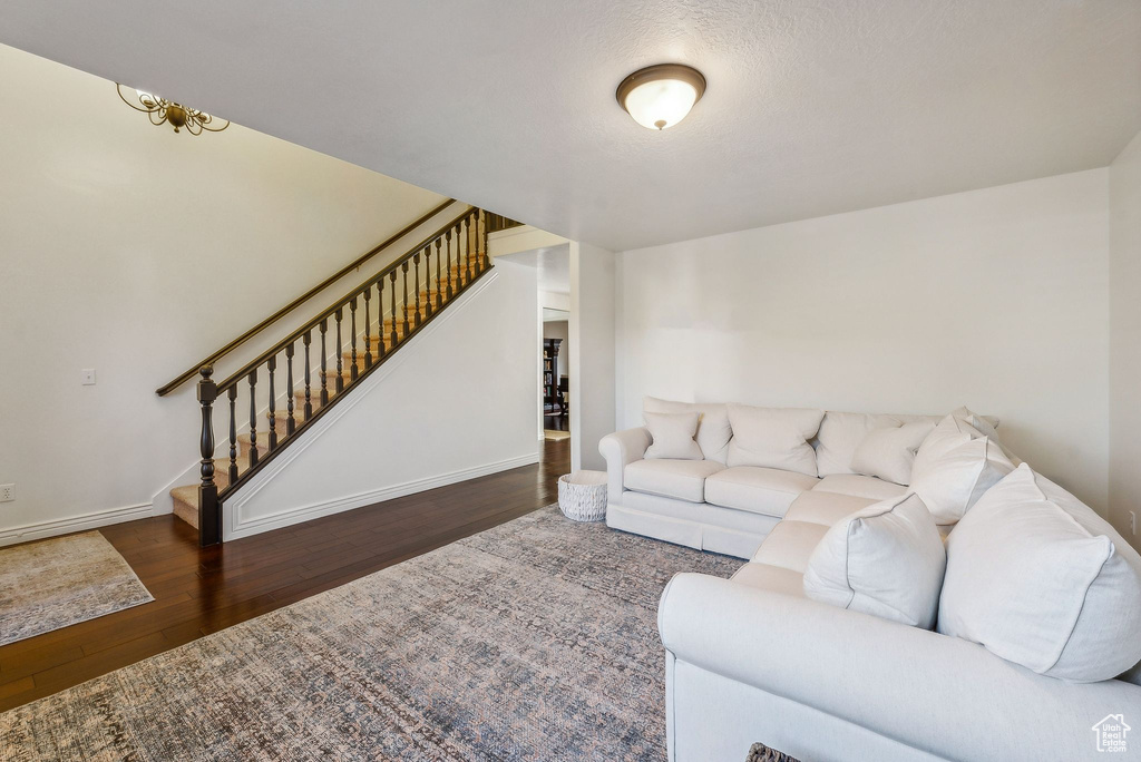 Living room with dark hardwood / wood-style flooring