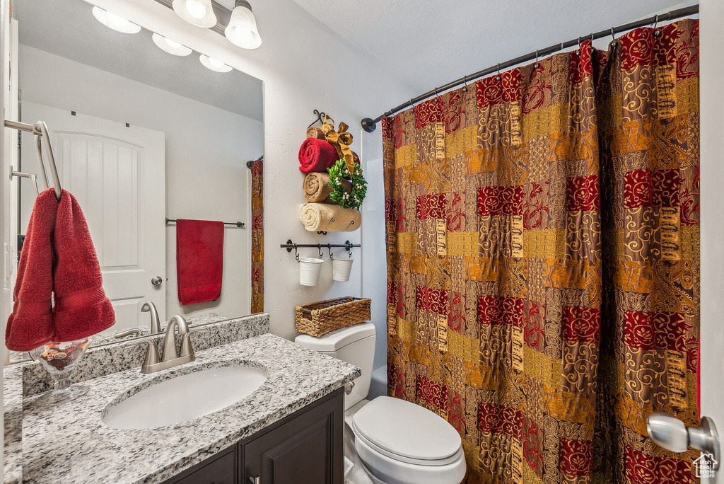 Bathroom featuring vanity and toilet