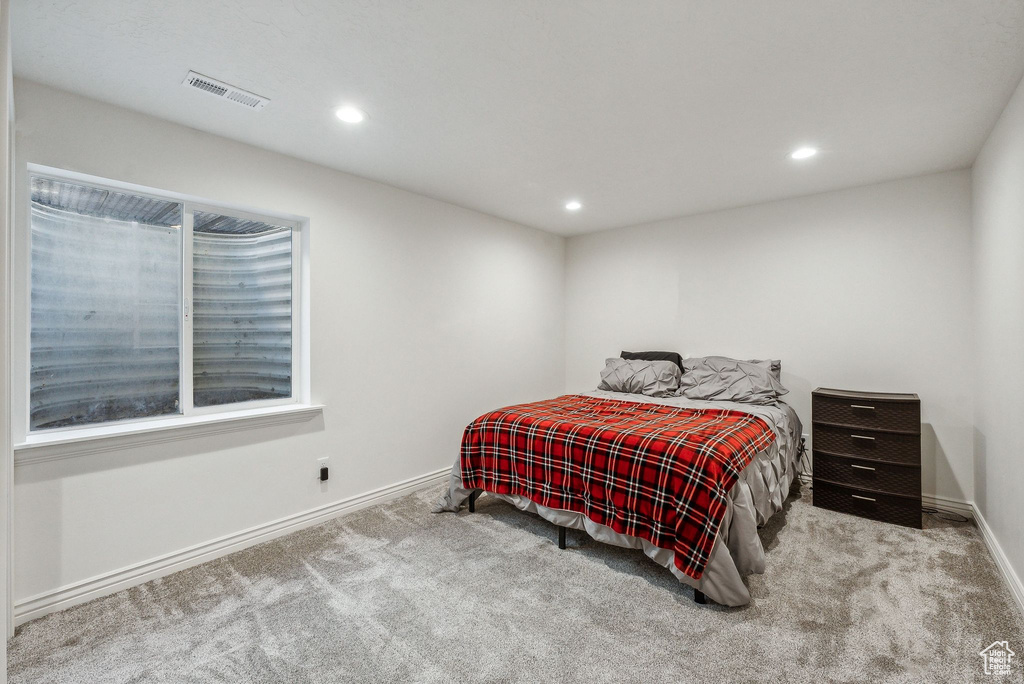 Bedroom featuring light colored carpet