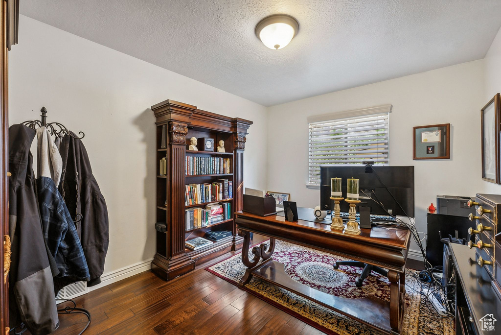 Office area featuring a textured ceiling and dark hardwood / wood-style floors