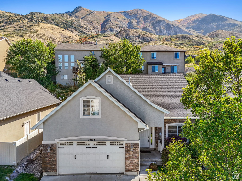 View of front facade featuring a garage and a mountain view