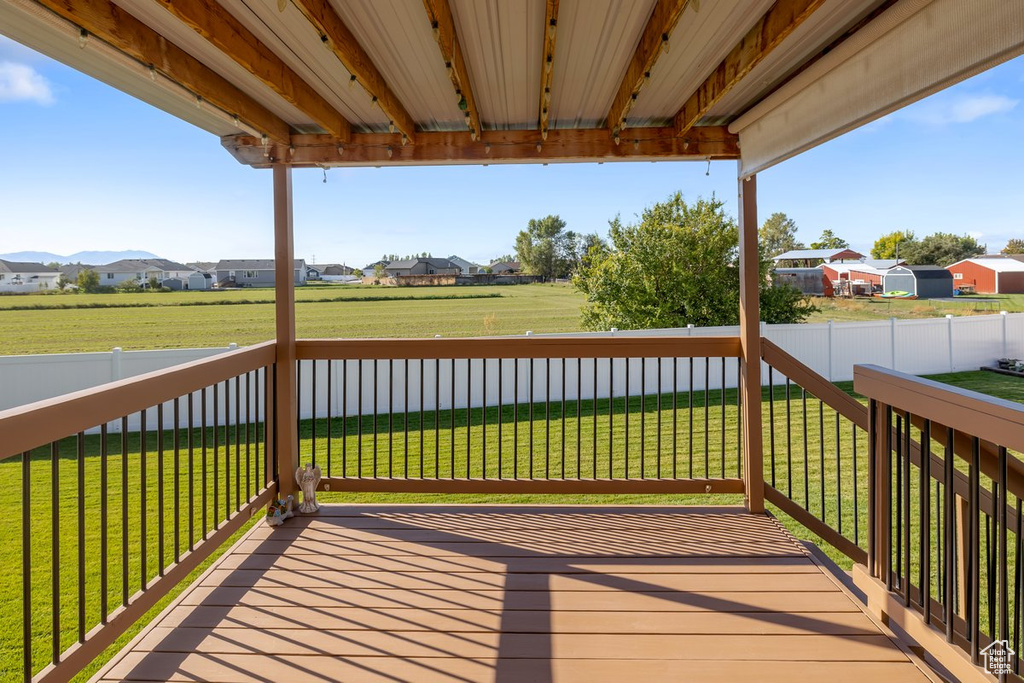 Wooden deck with a mountain view and a yard