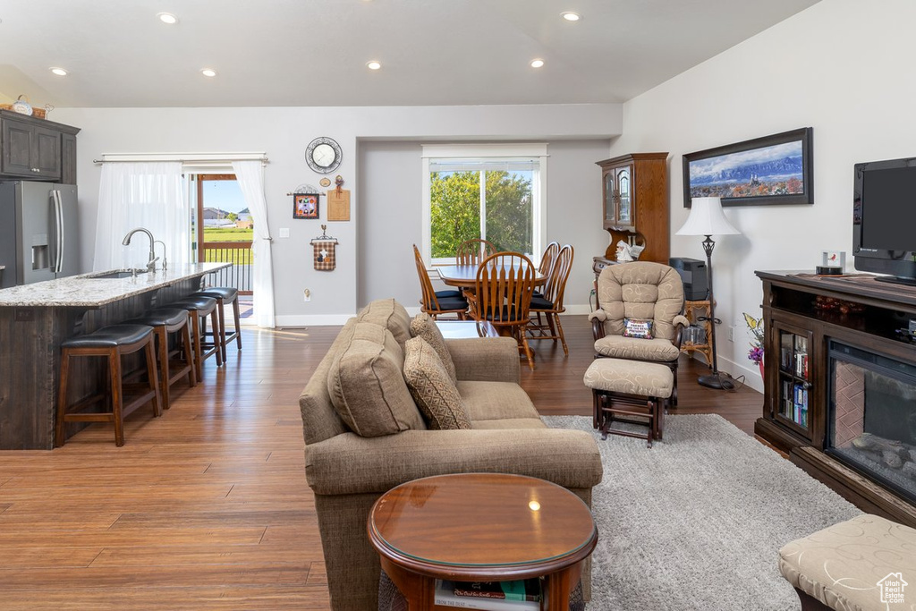 Living room with wood-type flooring and sink