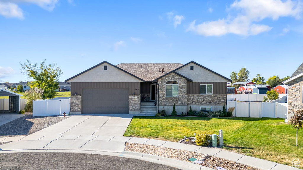 View of front of house featuring a front yard and a garage