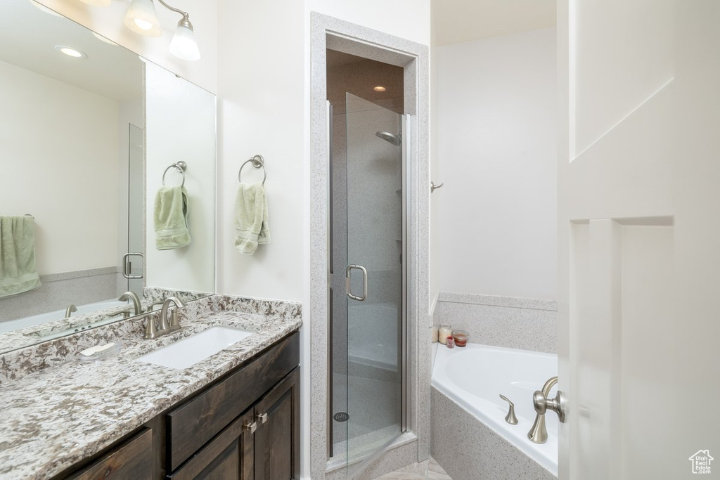 Bathroom with vanity and separate shower and tub