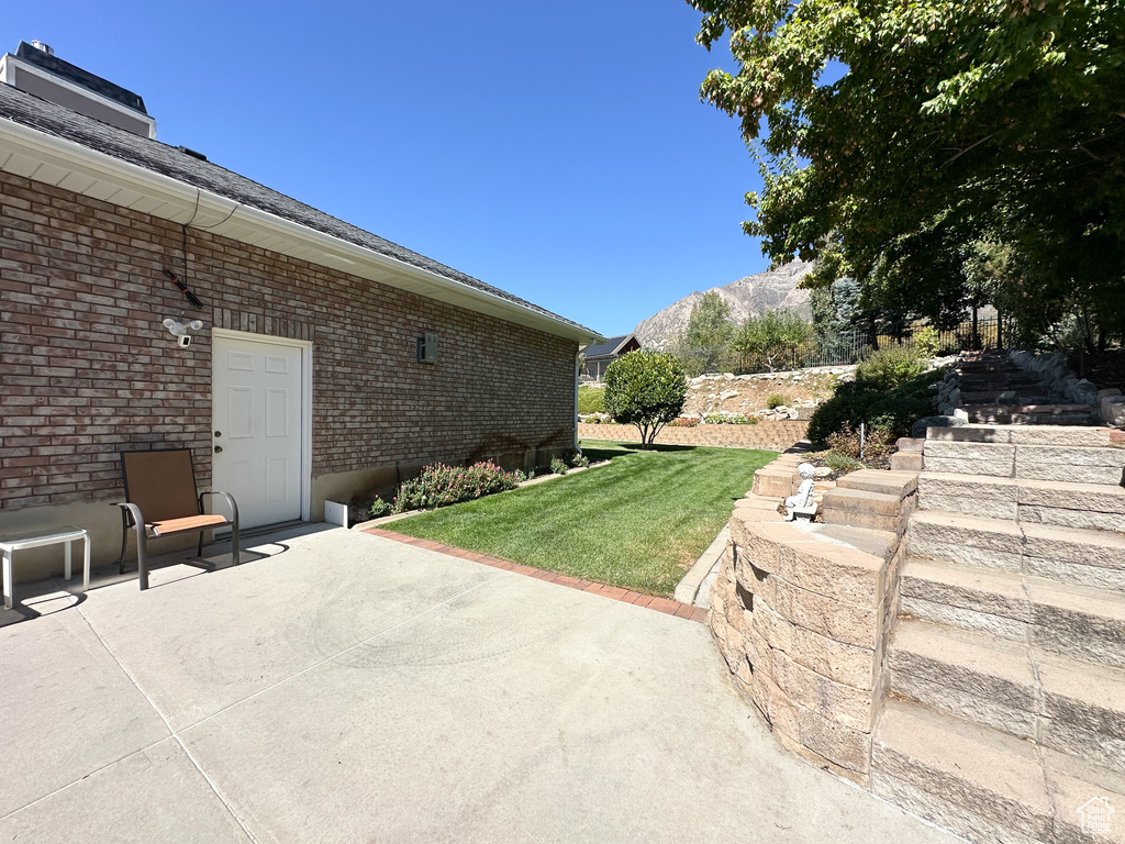 View of yard with a mountain view and a patio area