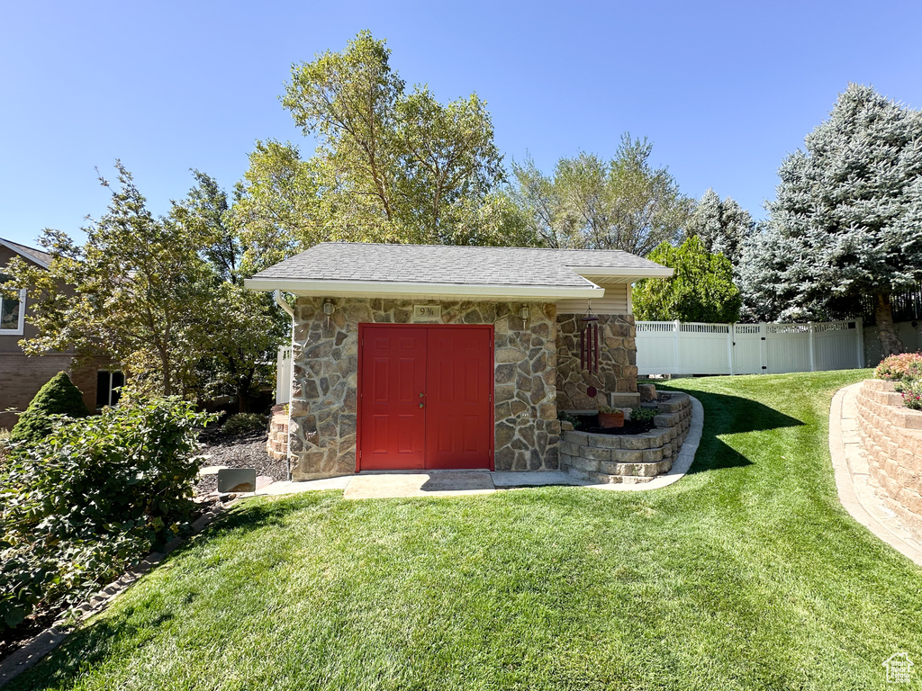 View of outdoor structure with a yard