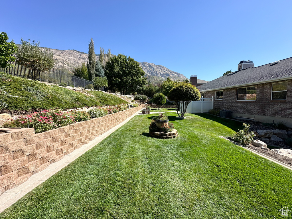 View of yard featuring a mountain view, a fire pit, and central AC