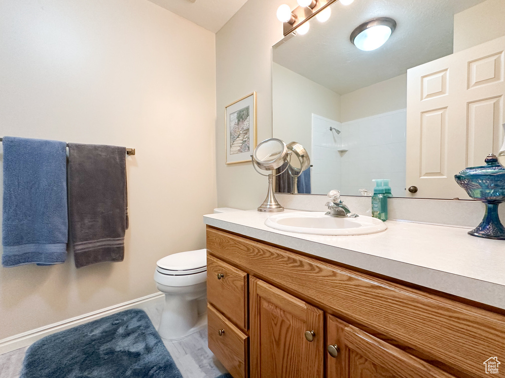 Bathroom with a shower, vanity, and toilet