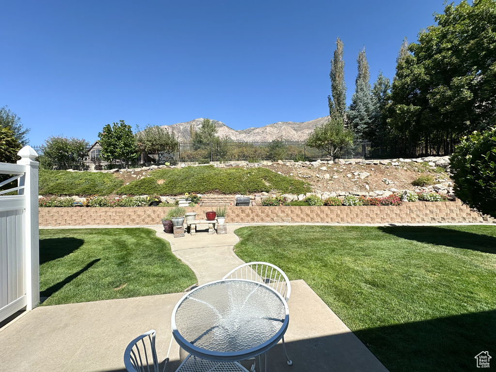 View of yard featuring a mountain view and a patio area