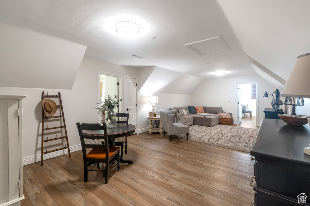 Living room featuring light wood-type flooring and vaulted ceiling