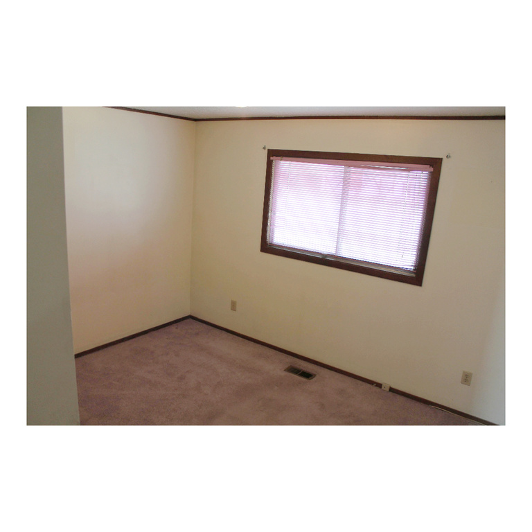 Spare room with carpet flooring, visible vents, and baseboards