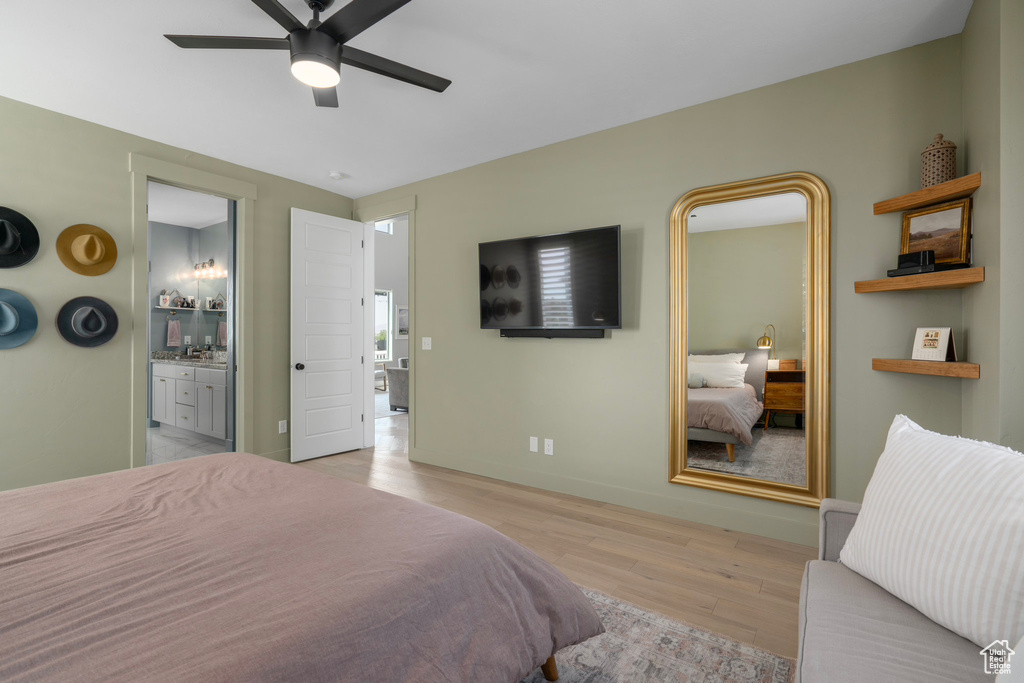 Bedroom featuring ceiling fan, light hardwood / wood-style flooring, and ensuite bath