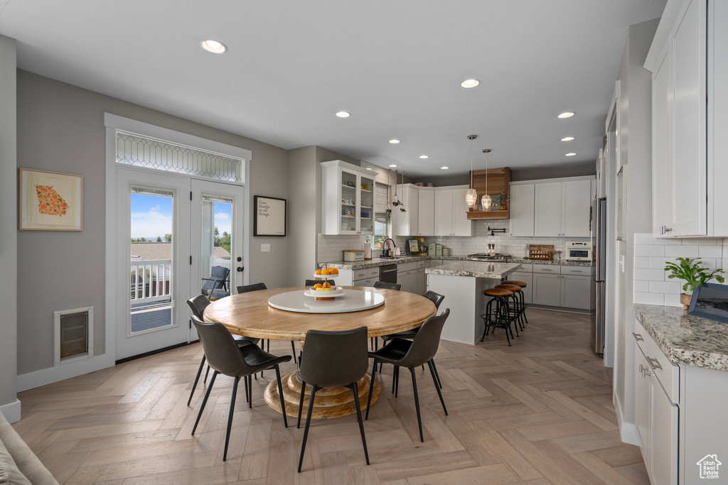 Dining area with light parquet flooring and sink