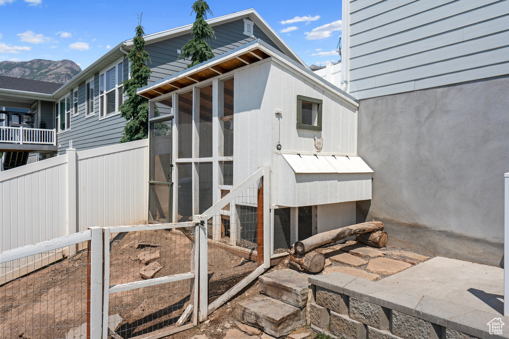 Rear view of house featuring a sunroom and a mountain view