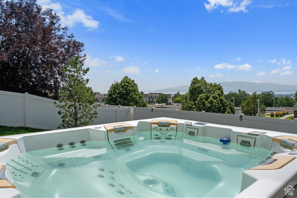 View of pool featuring a hot tub and a mountain view