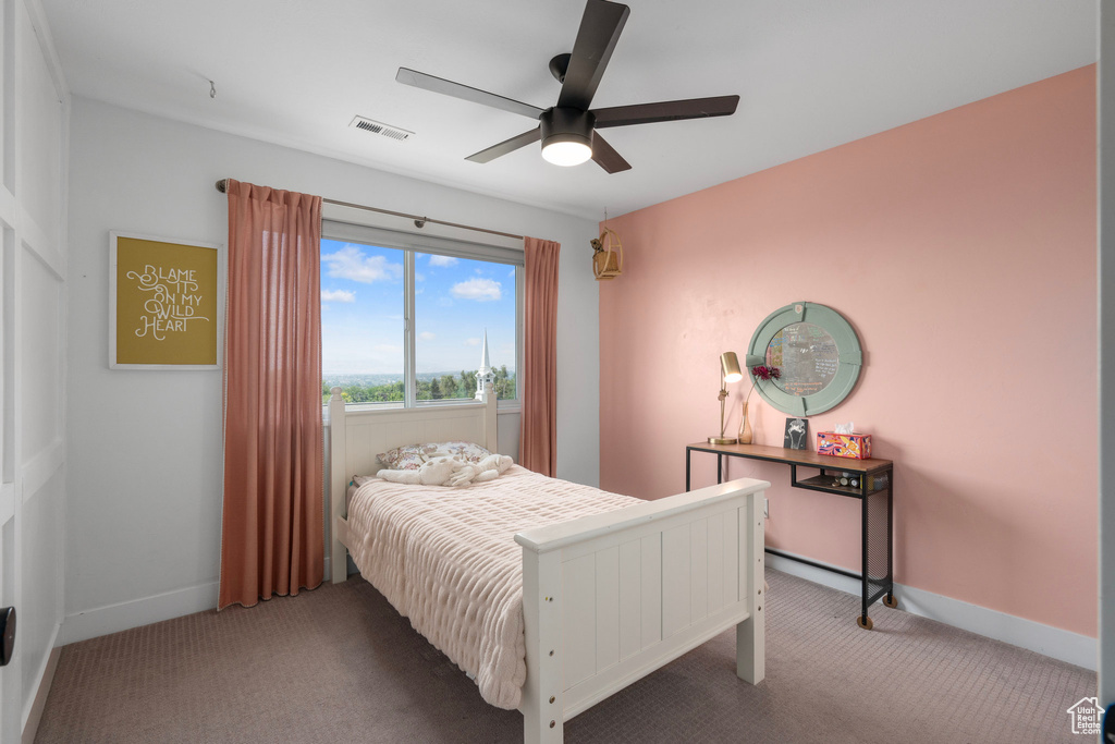 Bedroom featuring ceiling fan and carpet flooring