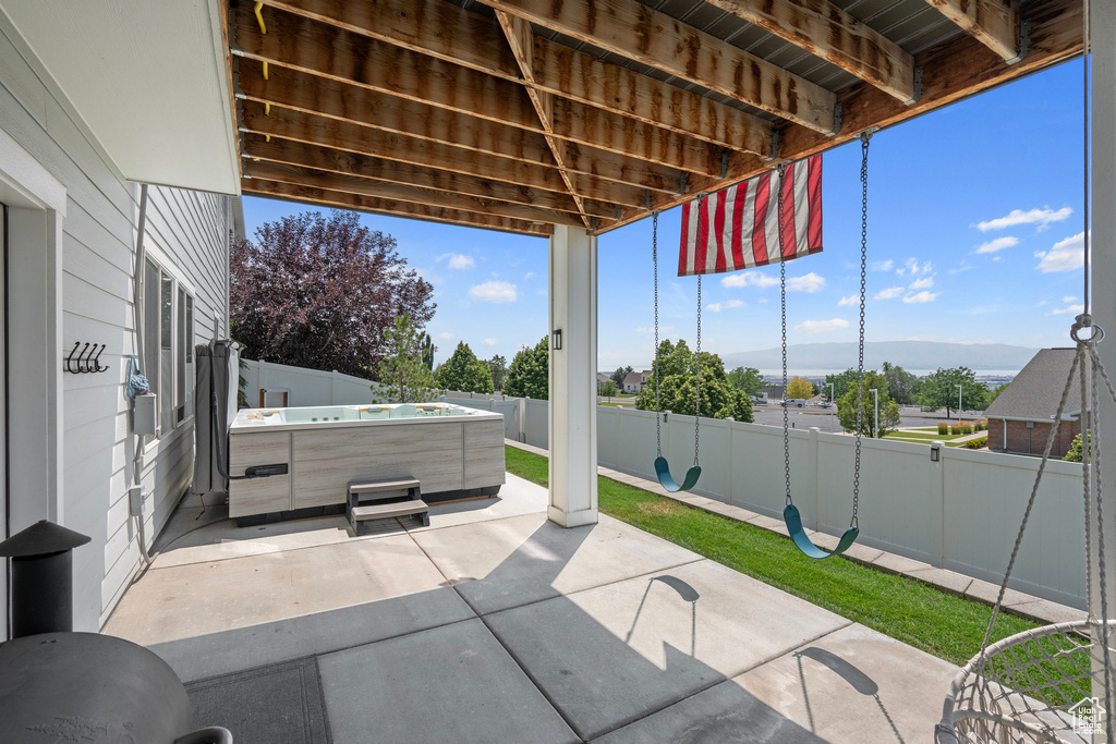 View of patio with a hot tub