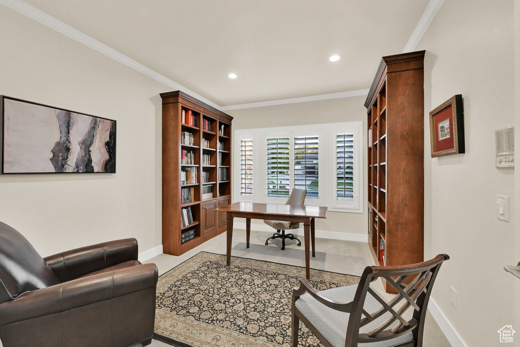 Carpeted office space with crown molding