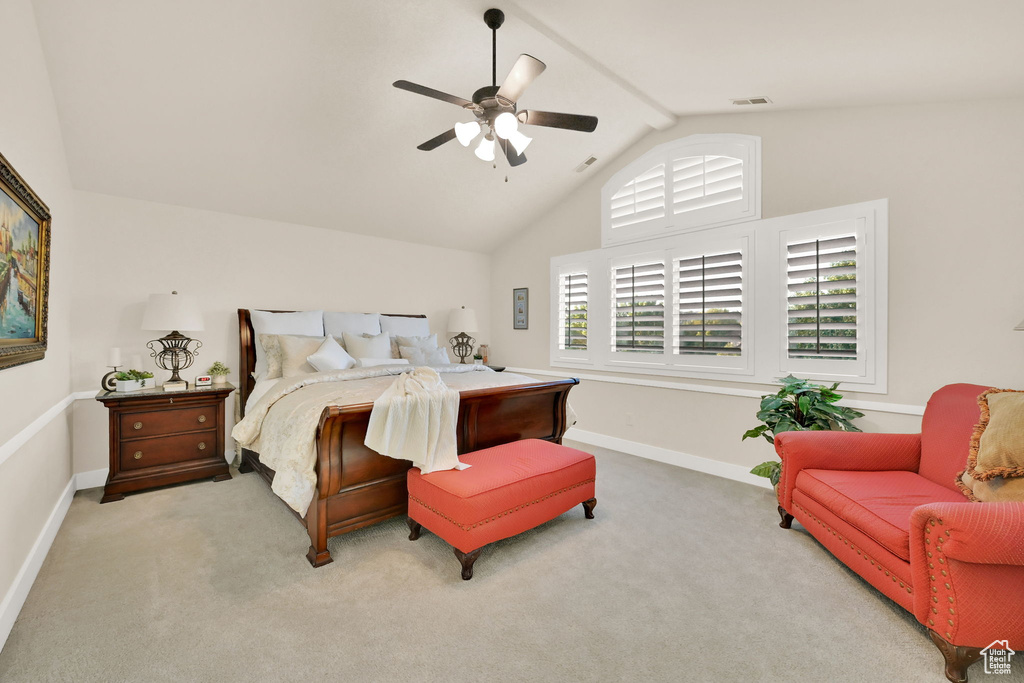 Bedroom featuring ceiling fan, light carpet, and vaulted ceiling