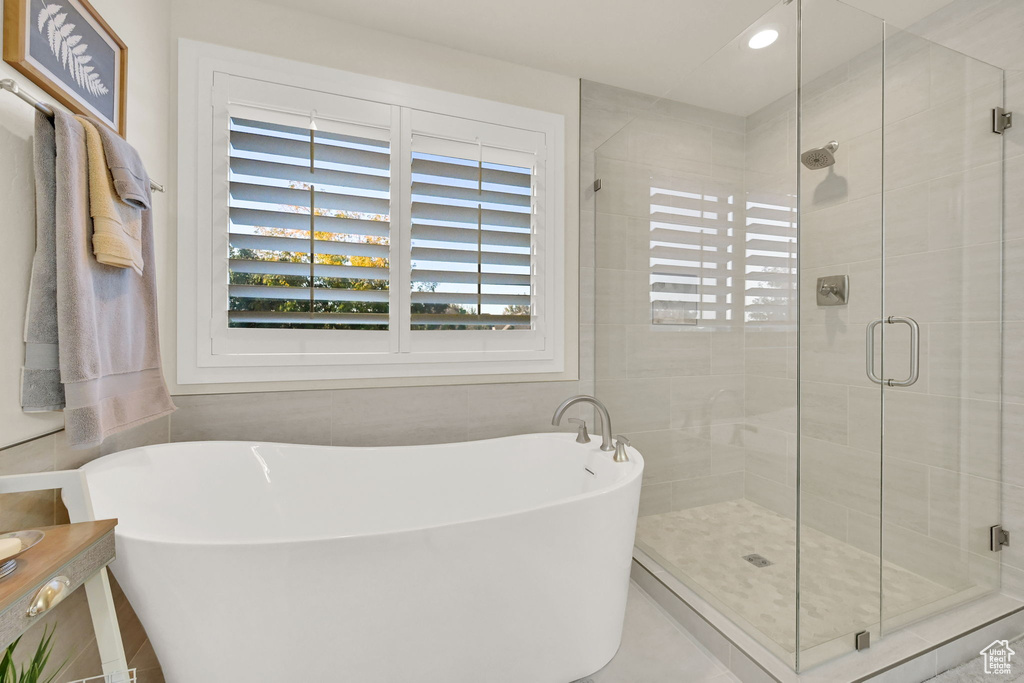 Bathroom featuring shower with separate bathtub