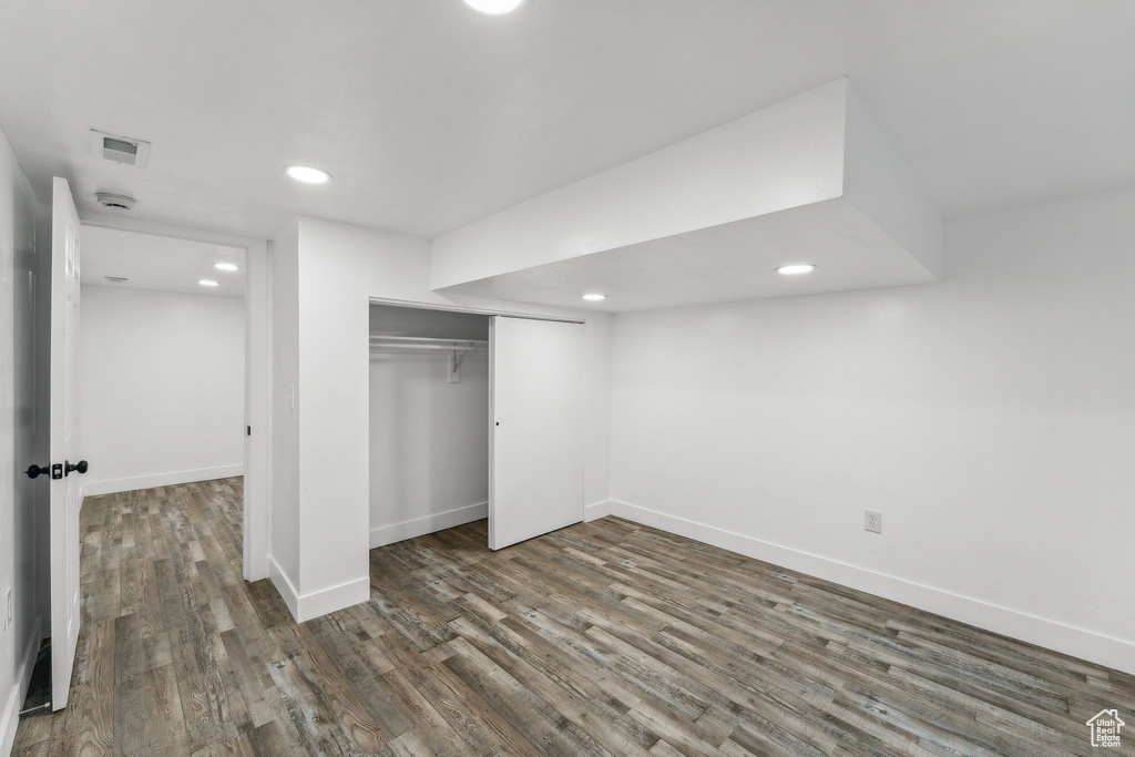 Unfurnished bedroom with dark wood-type flooring and a closet