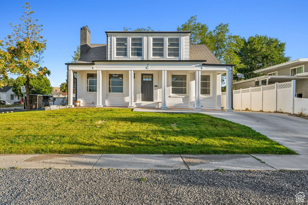 View of front of property featuring a porch and a front lawn