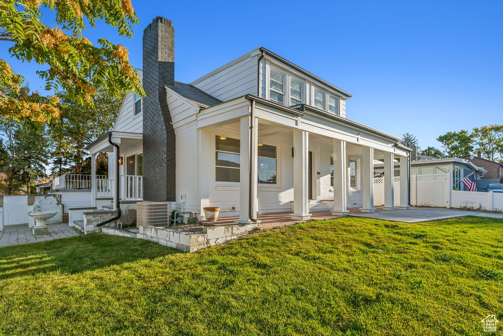 View of front of property with a front lawn and a porch