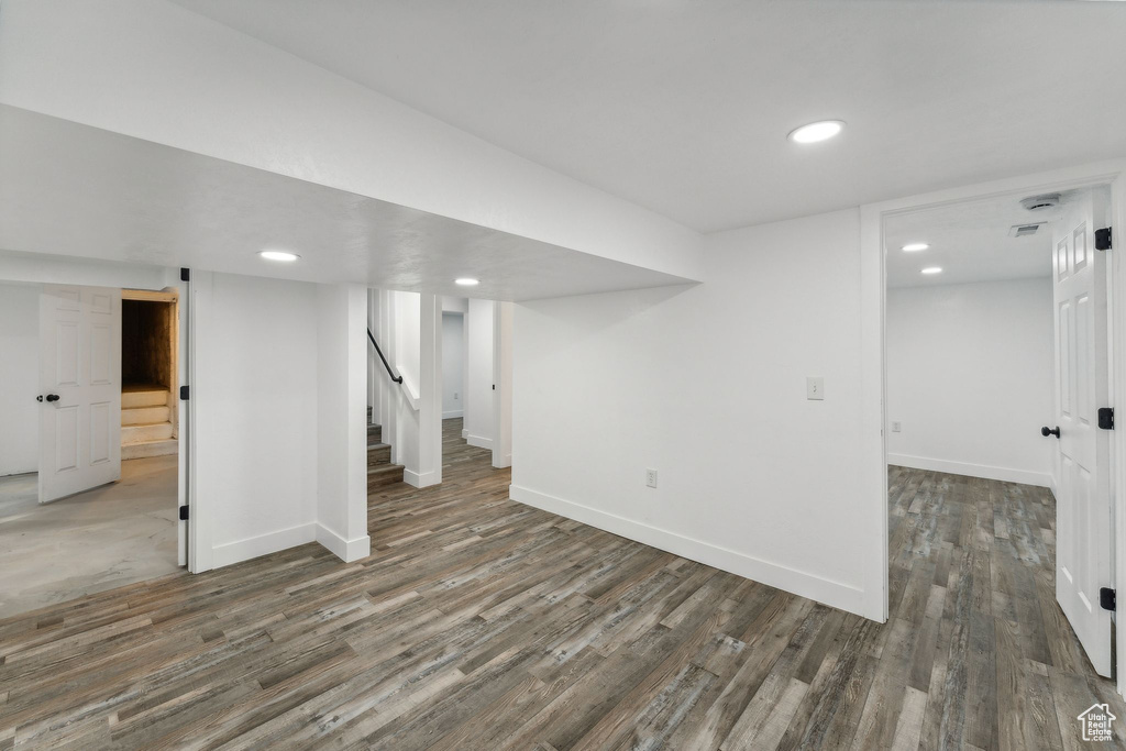 Basement with dark wood-type flooring