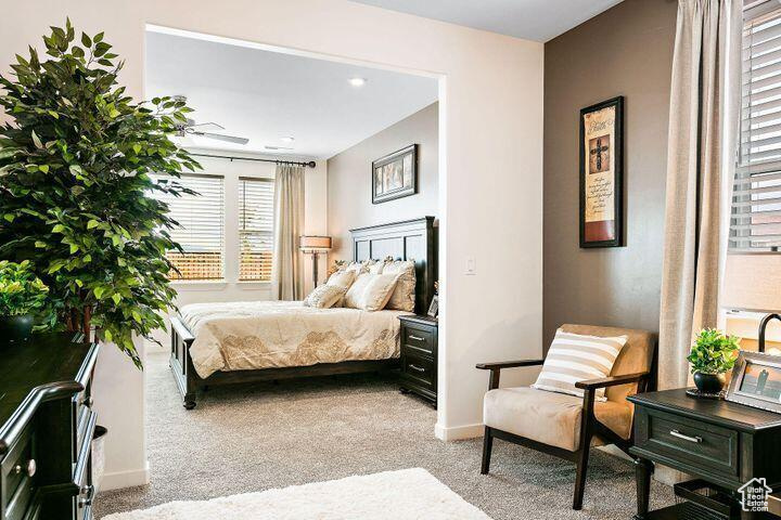 Bedroom featuring light carpet