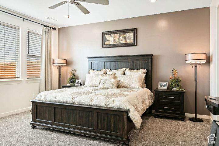 Bedroom featuring ceiling fan and light colored carpet