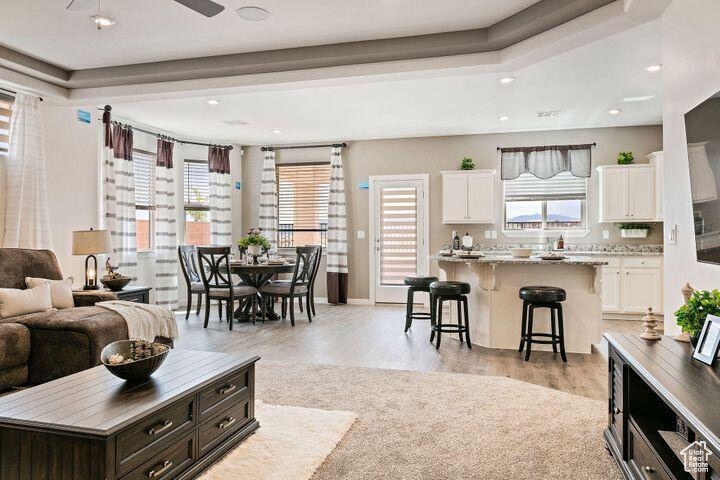 Living room with light wood-type flooring and ceiling fan