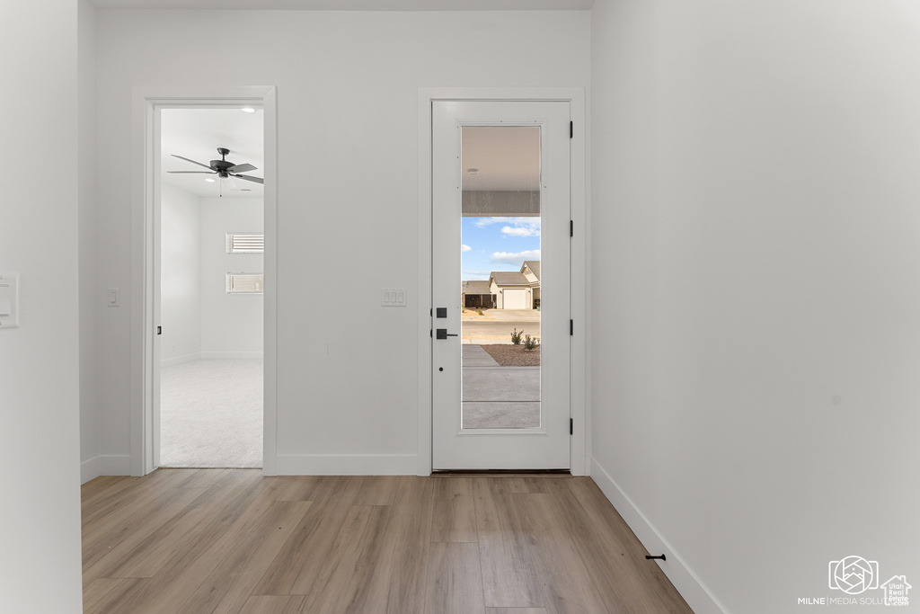 Interior space with ceiling fan and light wood-type flooring