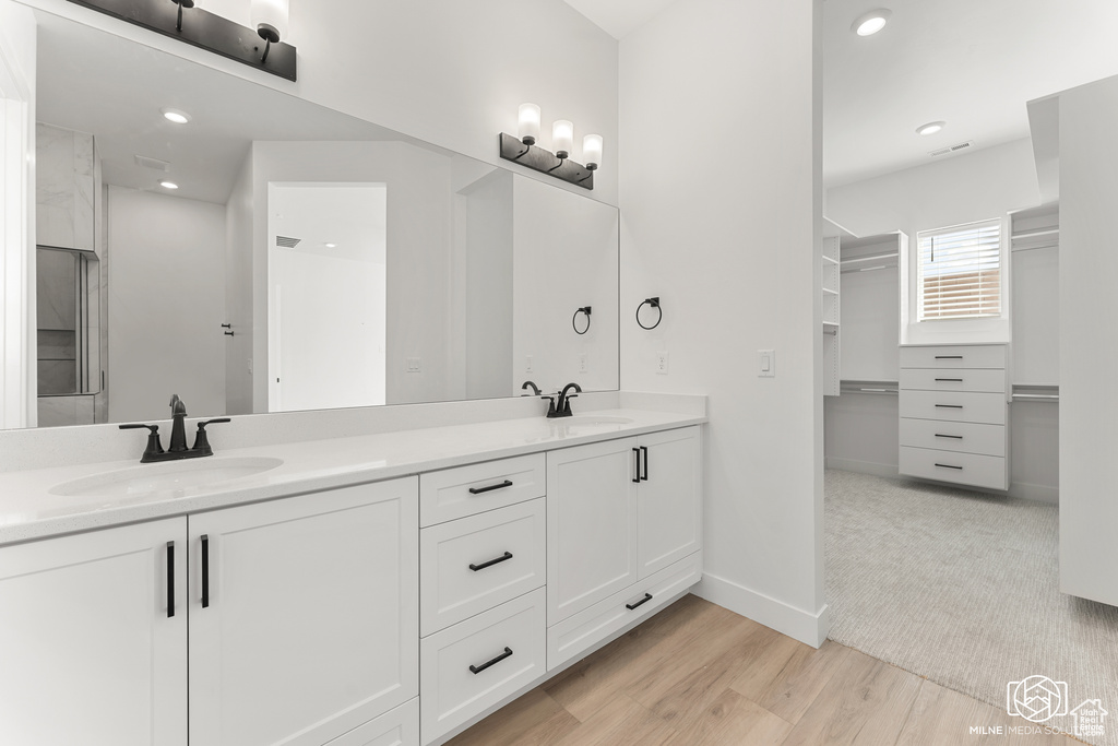 Bathroom featuring vanity and wood-type flooring